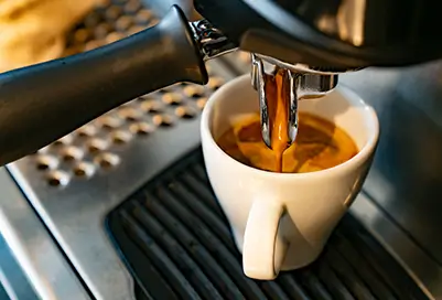 coffee being poured into a mug