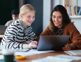 two women looking at a laptop