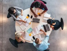 a group of students sitting around a table and studying