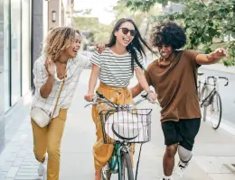 a group of friends laughing and smiling outside